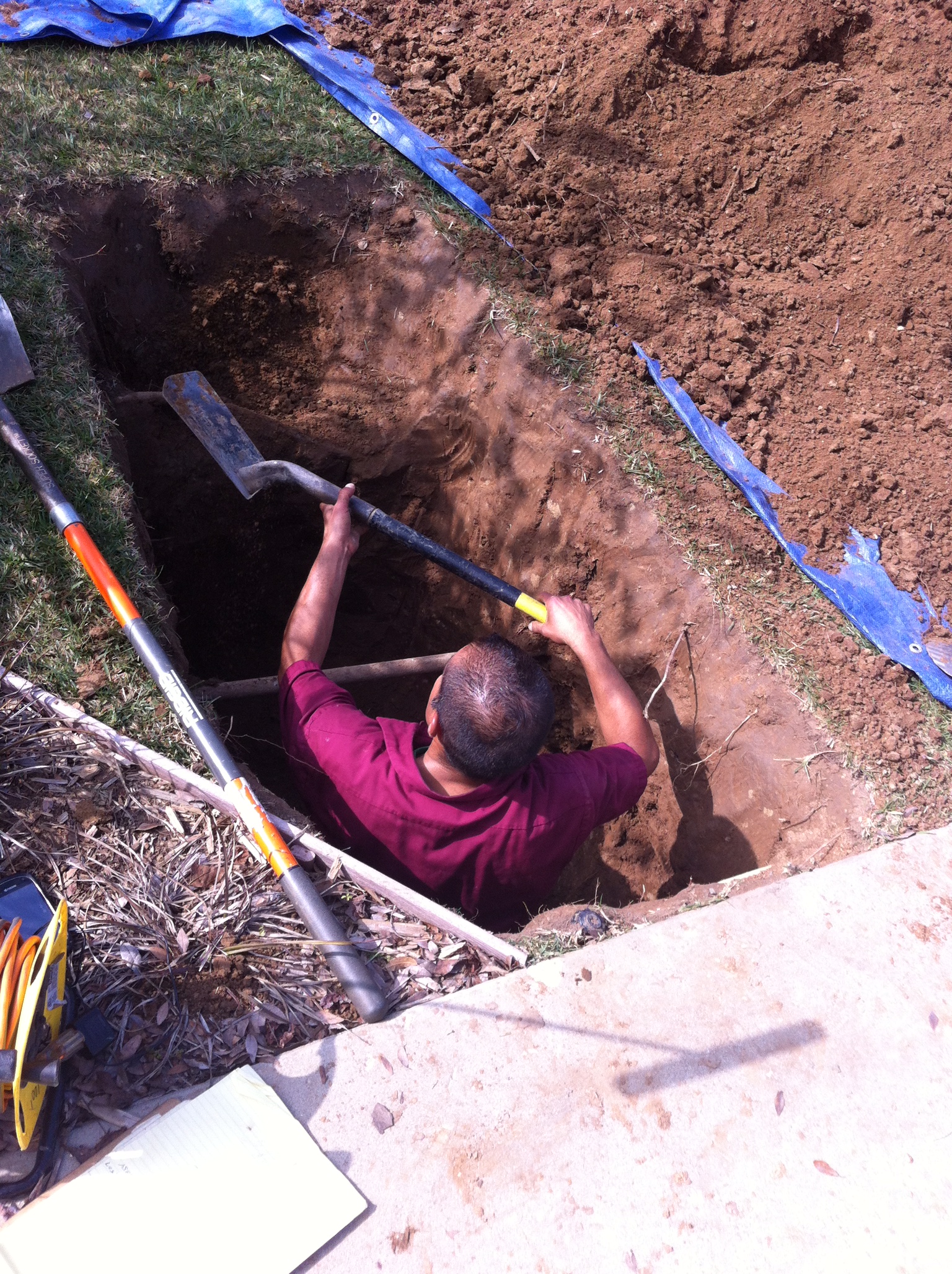 Picture of men digging deeop holes